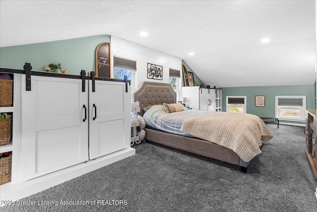bedroom featuring recessed lighting, a barn door, vaulted ceiling, and carpet floors