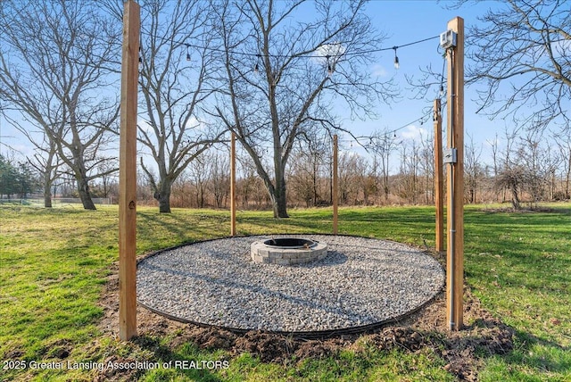 view of yard featuring an outdoor fire pit