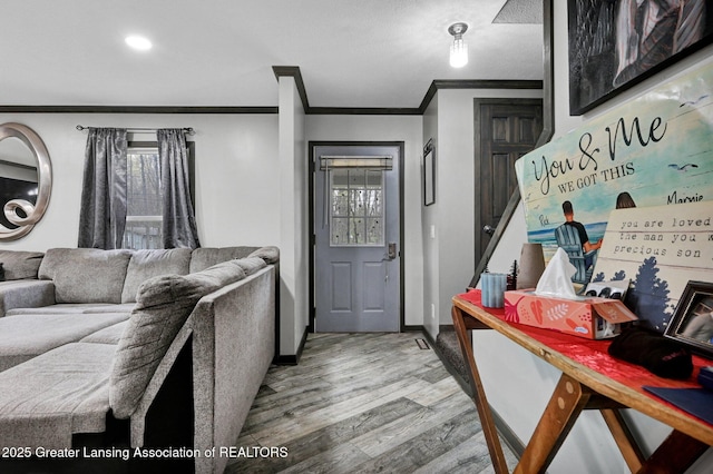 interior space with a wealth of natural light, wood finished floors, crown molding, and recessed lighting