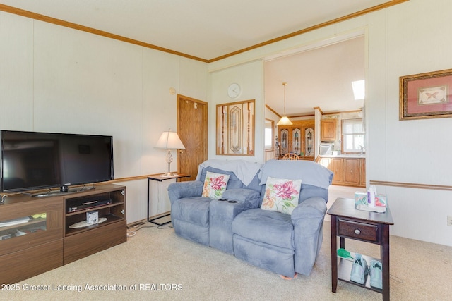 carpeted living area with high vaulted ceiling and ornamental molding