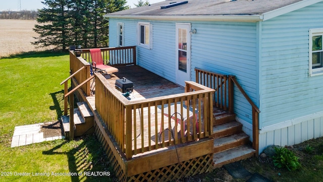 wooden terrace featuring a lawn