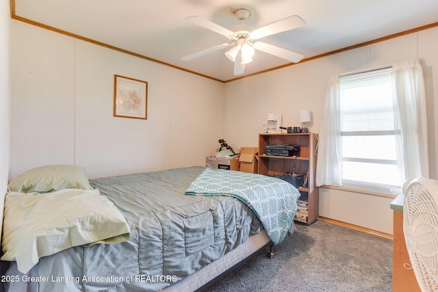 carpeted bedroom featuring crown molding and ceiling fan