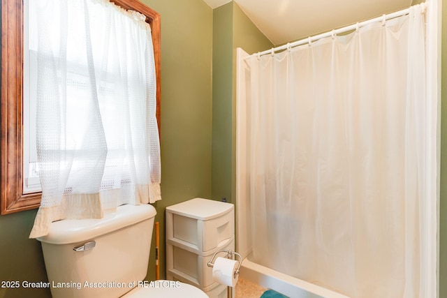 bathroom featuring toilet, a healthy amount of sunlight, and a shower with curtain
