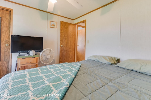 bedroom featuring a ceiling fan and ornamental molding