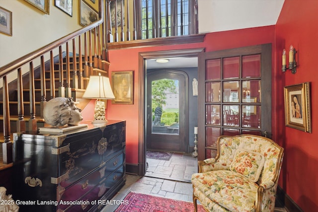 728 Audubon Rd, East Lansing, MI 48823 - foyer featuring stone tile floors, stairway, and a high ceiling