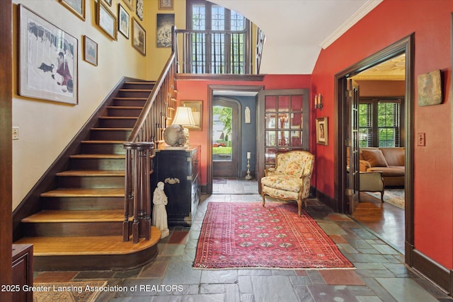 728 Audubon Rd, East Lansing, MI 48823 - foyer entrance with stone tile flooring, stairway, and ornamental molding