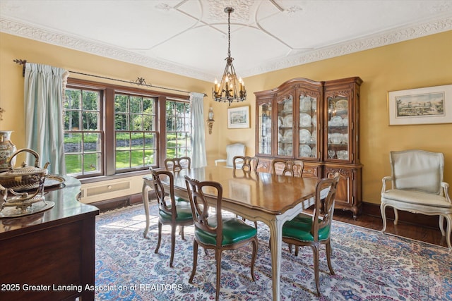 728 Audubon Rd, East Lansing, MI 48823 - dining area featuring a chandelier, dark wood finished floors, and ornamental molding