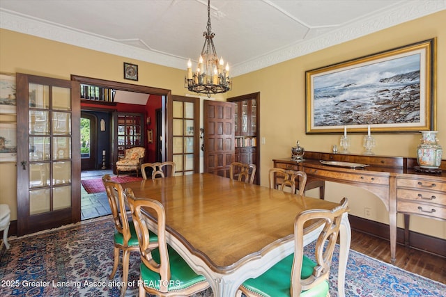 728 Audubon Rd, East Lansing, MI 48823 - dining space with french doors, a chandelier, and wood finished floors