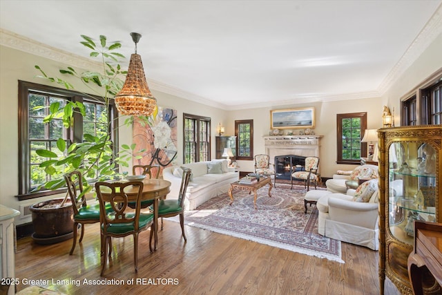 728 Audubon Rd, East Lansing, MI 48823 - living area with wood finished floors, a lit fireplace, and ornamental molding