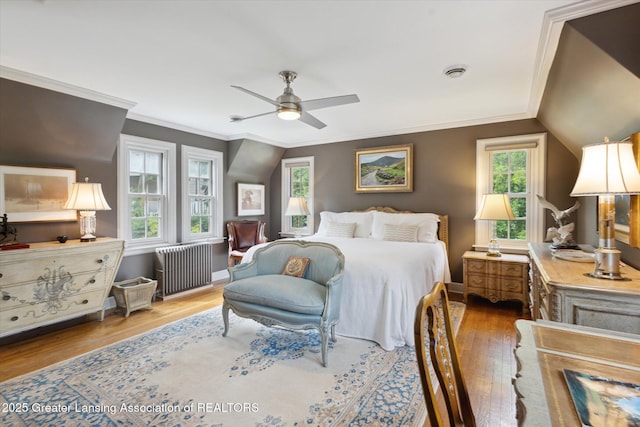 728 Audubon Rd, East Lansing, MI 48823 - bedroom featuring radiator heating unit, wood finished floors, crown molding, and a ceiling fan