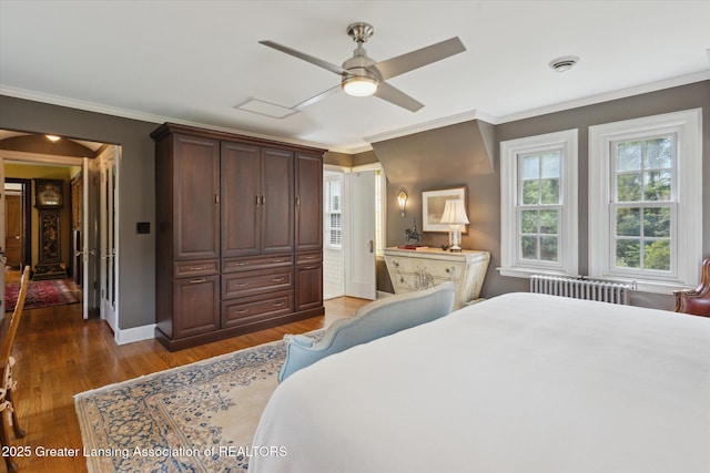728 Audubon Rd, East Lansing, MI 48823 - bedroom featuring radiator, dark wood-type flooring, crown molding, and ceiling fan