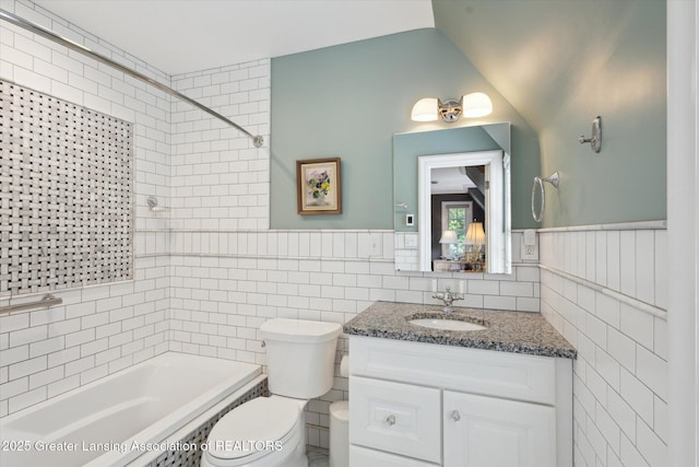 728 Audubon Rd, East Lansing, MI 48823 - full bathroom featuring tile walls, bathtub / shower combination, vanity, and a wainscoted wall