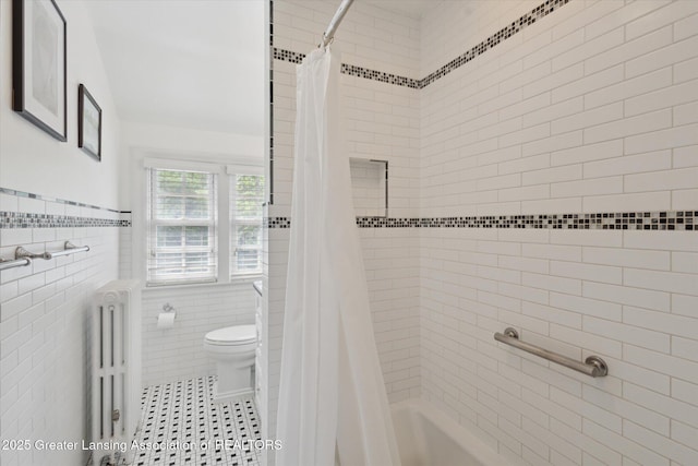728 Audubon Rd, East Lansing, MI 48823 - bathroom with radiator heating unit, tile walls, shower / bath combo, and wainscoting