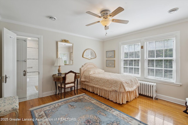 728 Audubon Rd, East Lansing, MI 48823 - bedroom with radiator heating unit, wood finished floors, ornamental molding, and connected bathroom
