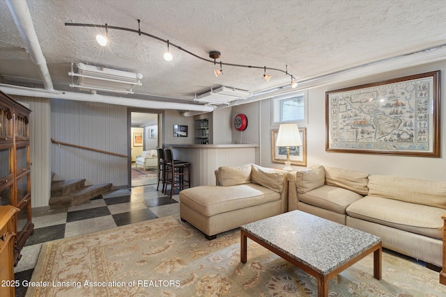 728 Audubon Rd, East Lansing, MI 48823 - living area with tile patterned floors, a textured ceiling, bar area, and stairs