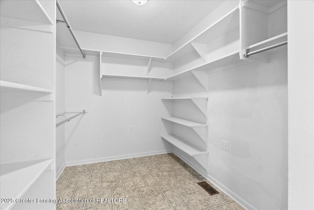 walk in closet with visible vents