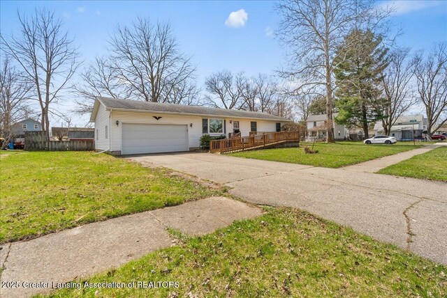 ranch-style house with a front yard, driveway, fence, and an attached garage