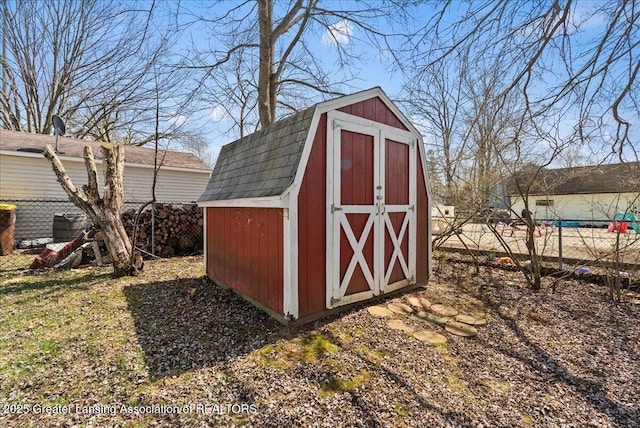 view of shed featuring fence