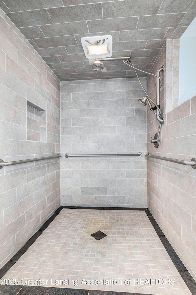 bathroom with tiled shower