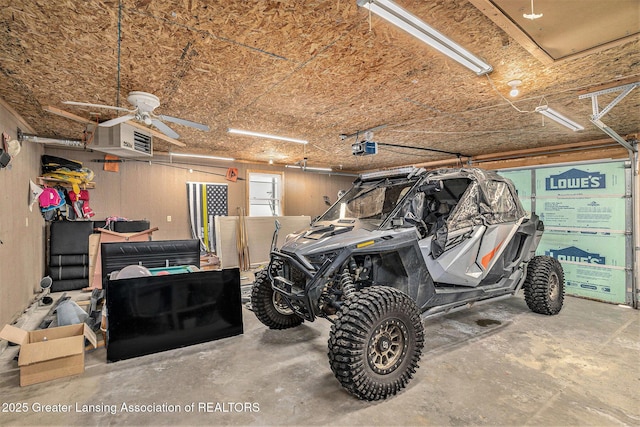 garage with a garage door opener and a ceiling fan