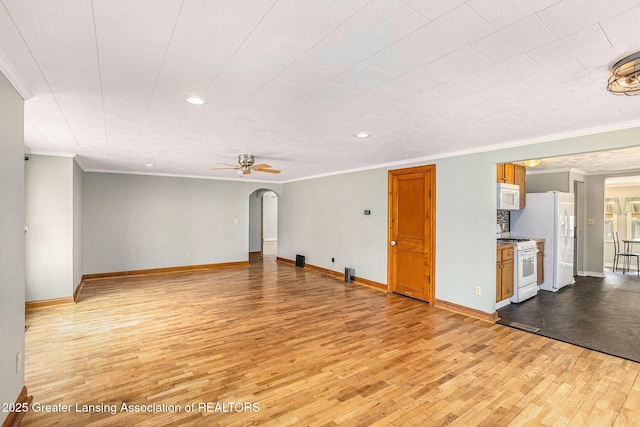 unfurnished living room with baseboards, ornamental molding, ceiling fan, recessed lighting, and light wood-style flooring