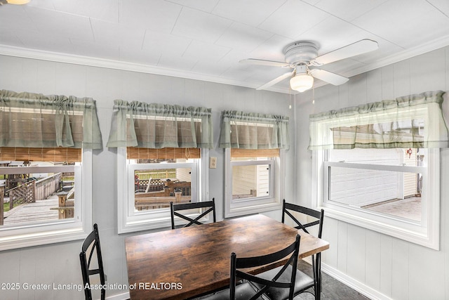 dining space featuring baseboards, crown molding, and a ceiling fan