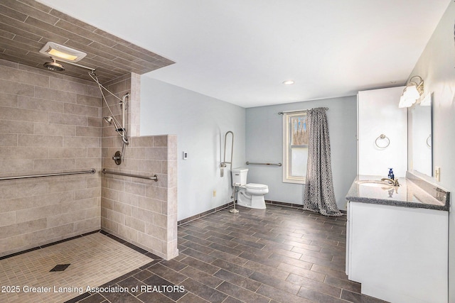 bathroom with vanity, baseboards, recessed lighting, toilet, and a tile shower