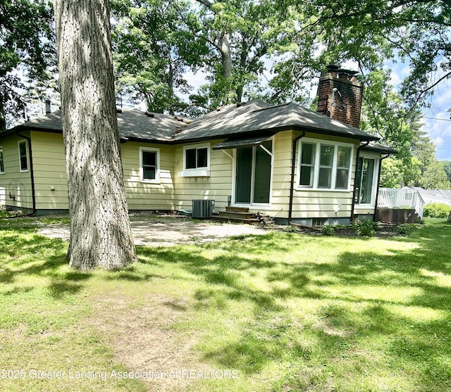 629 Swains Lake Dr, Concord, MI 49237 - back of house featuring a chimney, a lawn, and entry steps