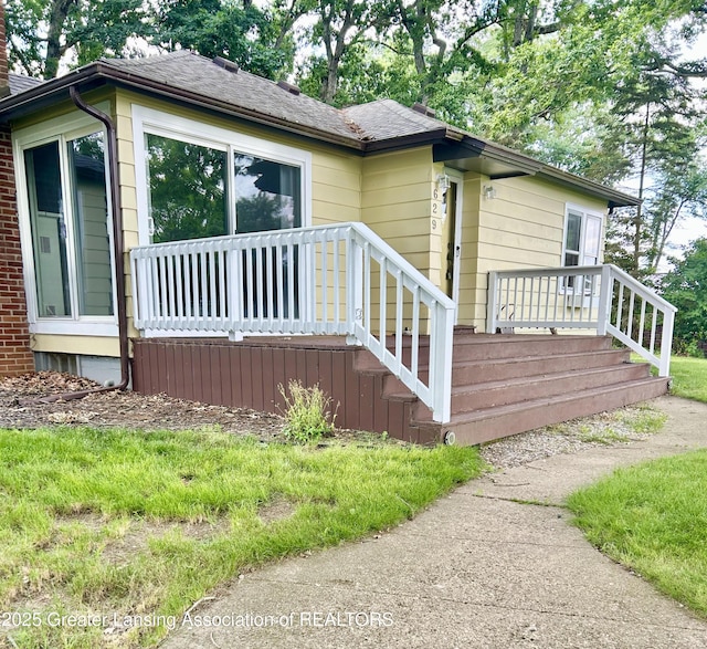 629 Swains Lake Dr, Concord, MI 49237 - view of side of home featuring a deck, a chimney, and a shingled roof