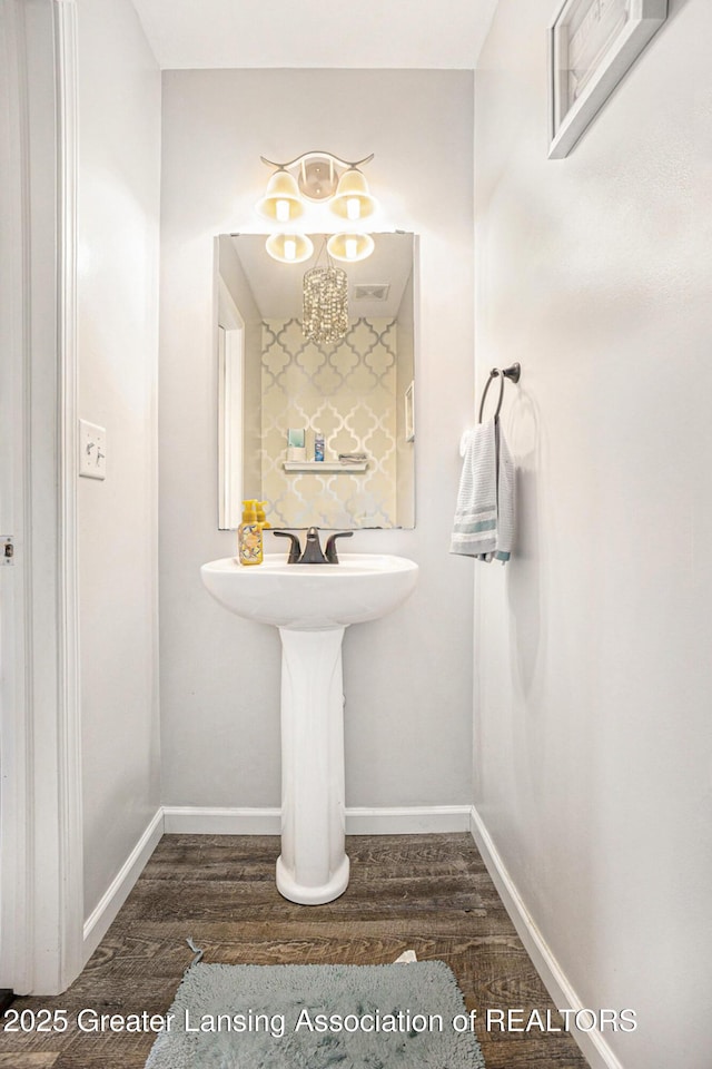 bathroom featuring baseboards and wood finished floors