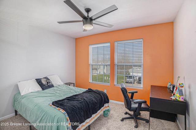carpeted bedroom featuring a ceiling fan and baseboards