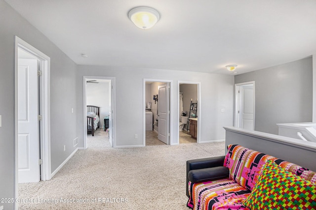bedroom with carpet floors, baseboards, and connected bathroom