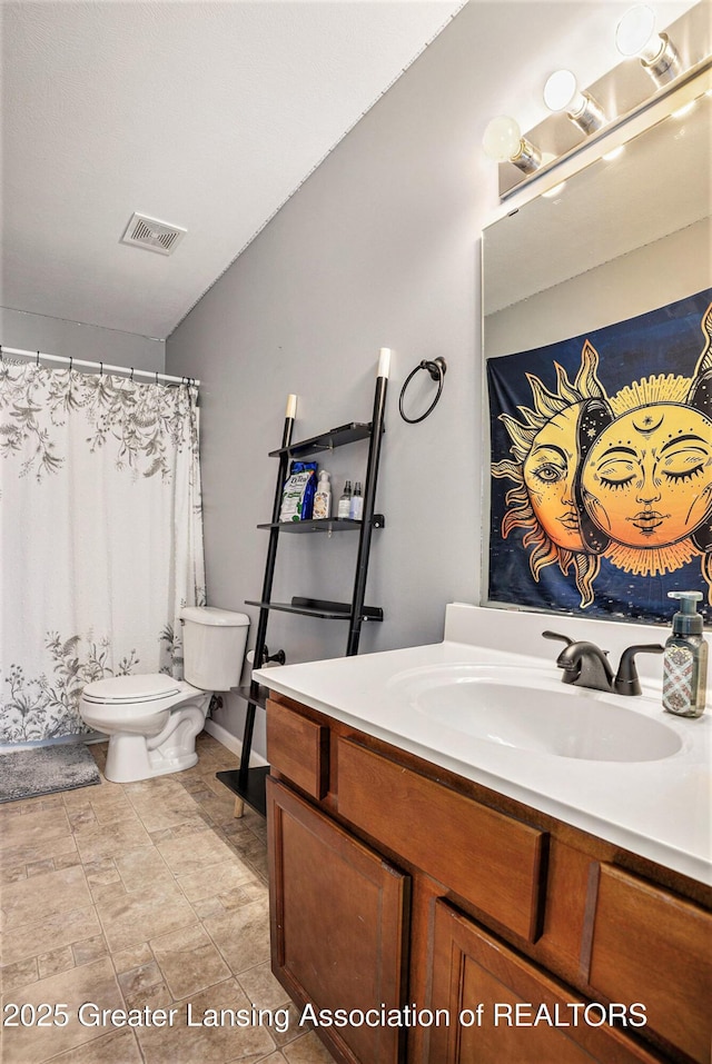 bathroom featuring visible vents, vanity, and toilet