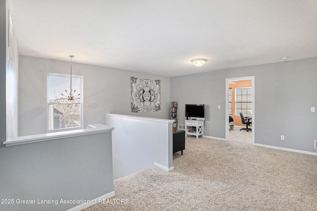 interior space with baseboards, a healthy amount of sunlight, carpet flooring, and an upstairs landing
