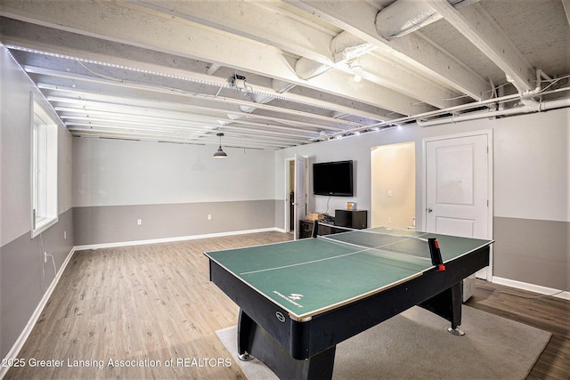 recreation room with baseboards and wood finished floors
