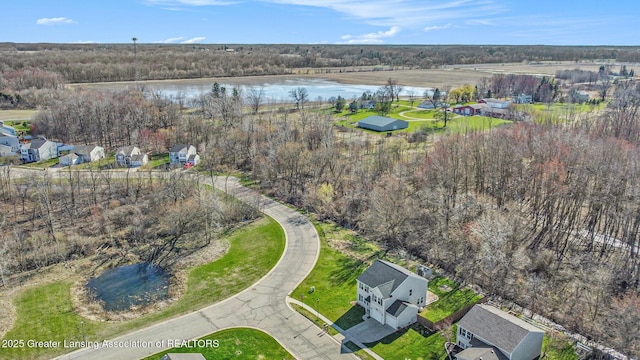 drone / aerial view featuring a residential view and a water view
