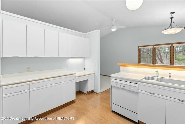 kitchen featuring dishwasher, white cabinets, vaulted ceiling, and light countertops