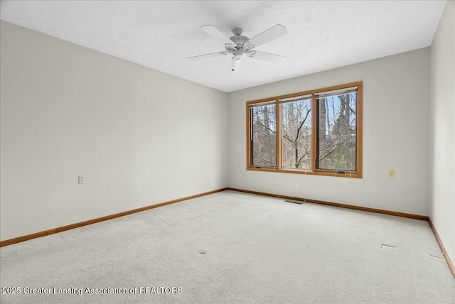 unfurnished room with baseboards, carpet flooring, and visible vents