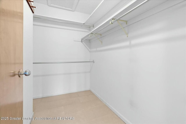 walk in closet with tile patterned floors