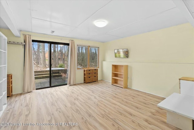 unfurnished dining area featuring wood finished floors and visible vents