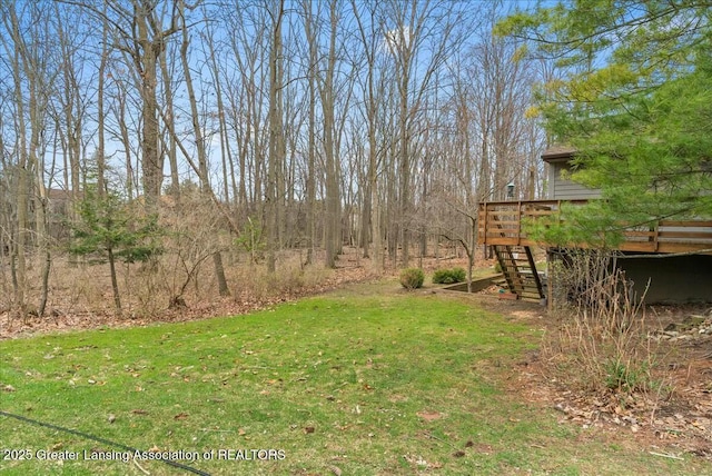 view of yard with a wooden deck and stairway