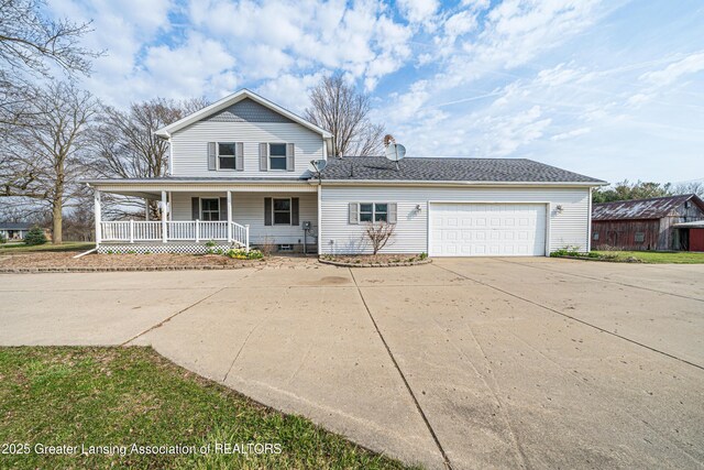 13577 Upton Rd, Bath, MI 48808 - view of front of house featuring a porch, a garage, driveway, and a chimney