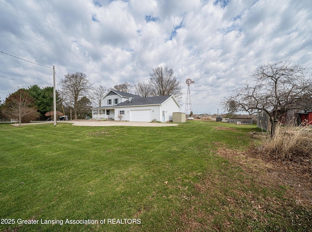 13577 Upton Rd, Bath, MI 48808 - view of front facade featuring a garage, a front yard, and driveway