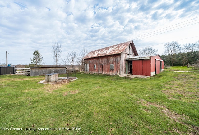 13577 Upton Rd, Bath, MI 48808 - view of yard featuring an outbuilding and a barn