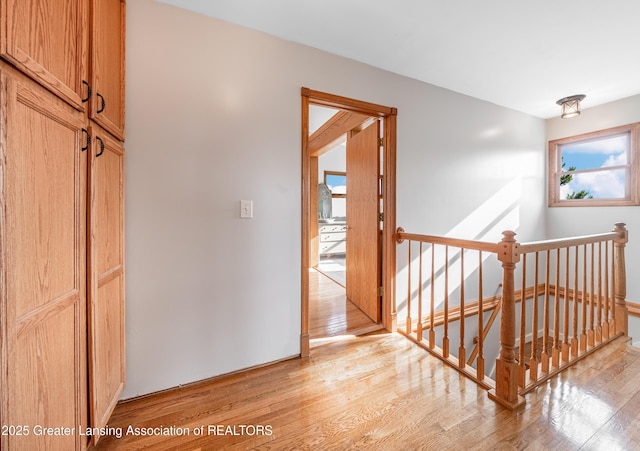 13577 Upton Rd, Bath, MI 48808 - corridor with an upstairs landing and light wood-style flooring