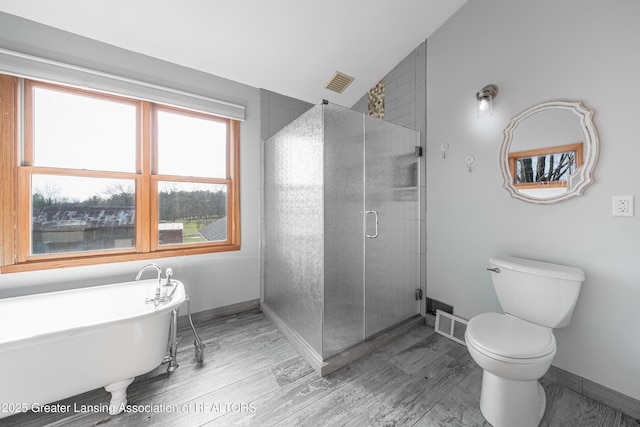 13577 Upton Rd, Bath, MI 48808 - full bath featuring a freestanding tub, wood finished floors, toilet, a shower stall, and baseboards