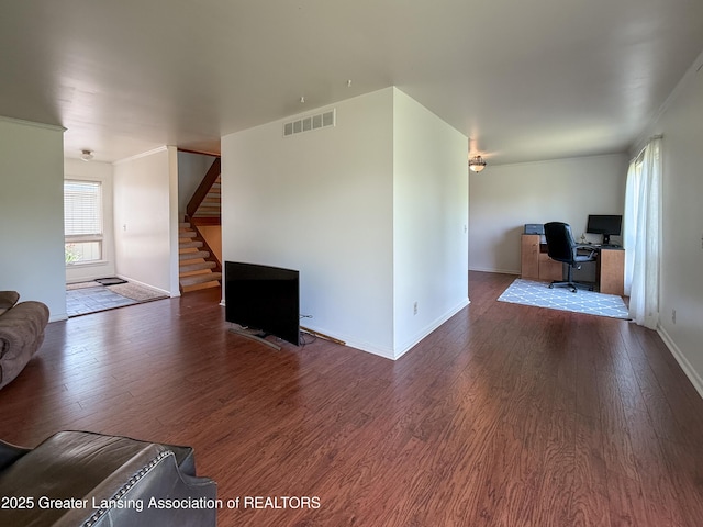 515 N Putnam St Unit B, Williamston, MI 48895 - living area with an office area, wood finished floors, stairs, baseboards, and crown molding