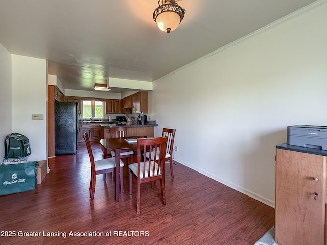 515 N Putnam St Unit B, Williamston, MI 48895 - dining space with dark wood-type flooring, baseboards, and ornamental molding