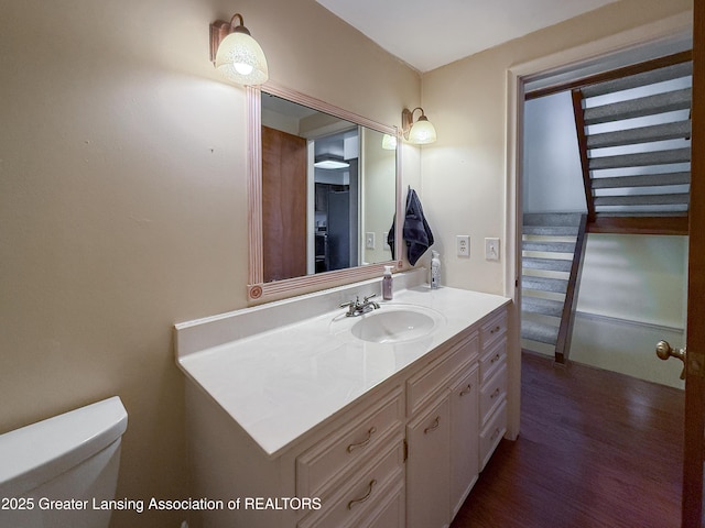 515 N Putnam St Unit B, Williamston, MI 48895 - half bath with vanity, toilet, and wood finished floors