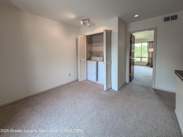 515 N Putnam St Unit B, Williamston, MI 48895 - unfurnished bedroom featuring separate washer and dryer, carpet, baseboards, a closet, and recessed lighting